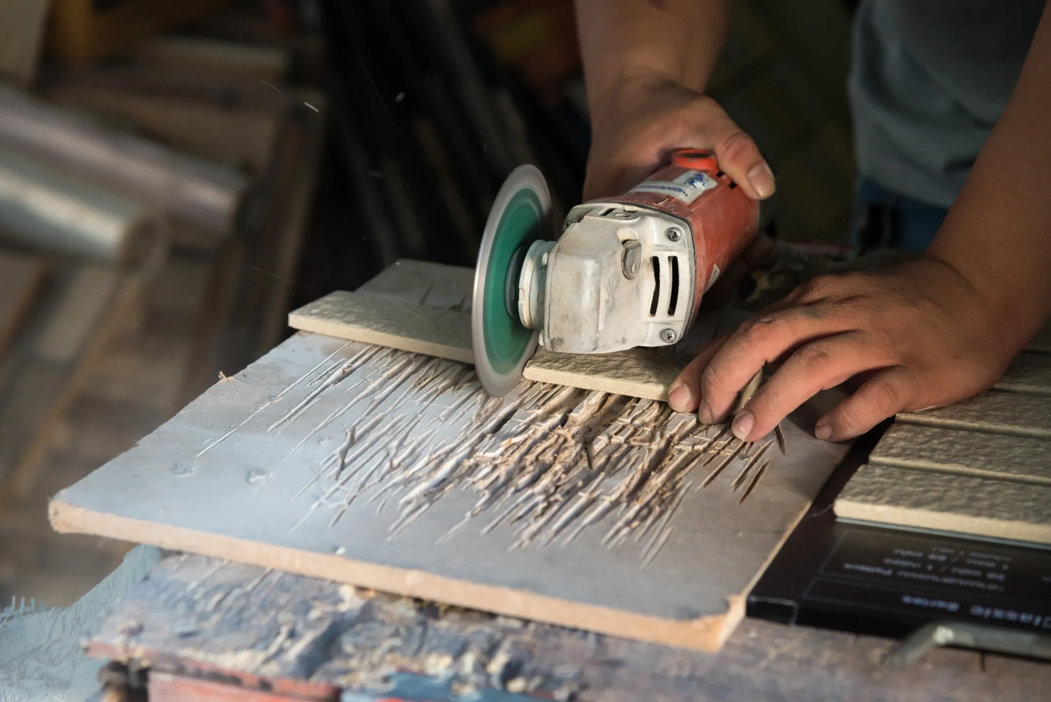 A person using an angle grinder on wood.